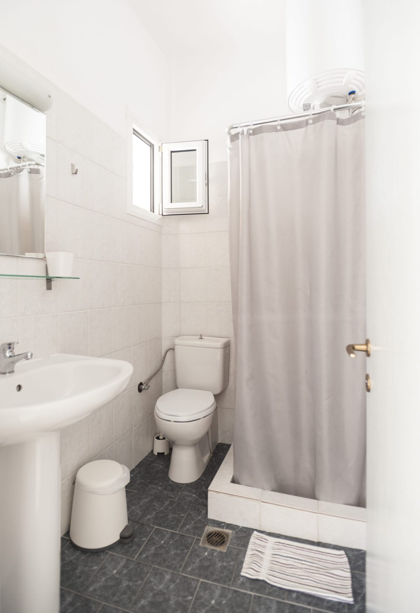 Bathroom with shower curtain and window