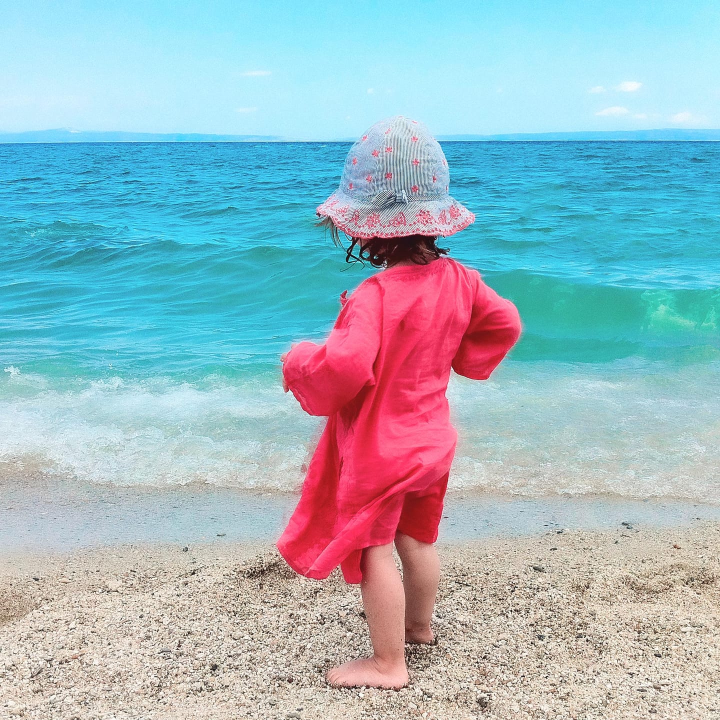 Child at the water's edge on Polychrono beach