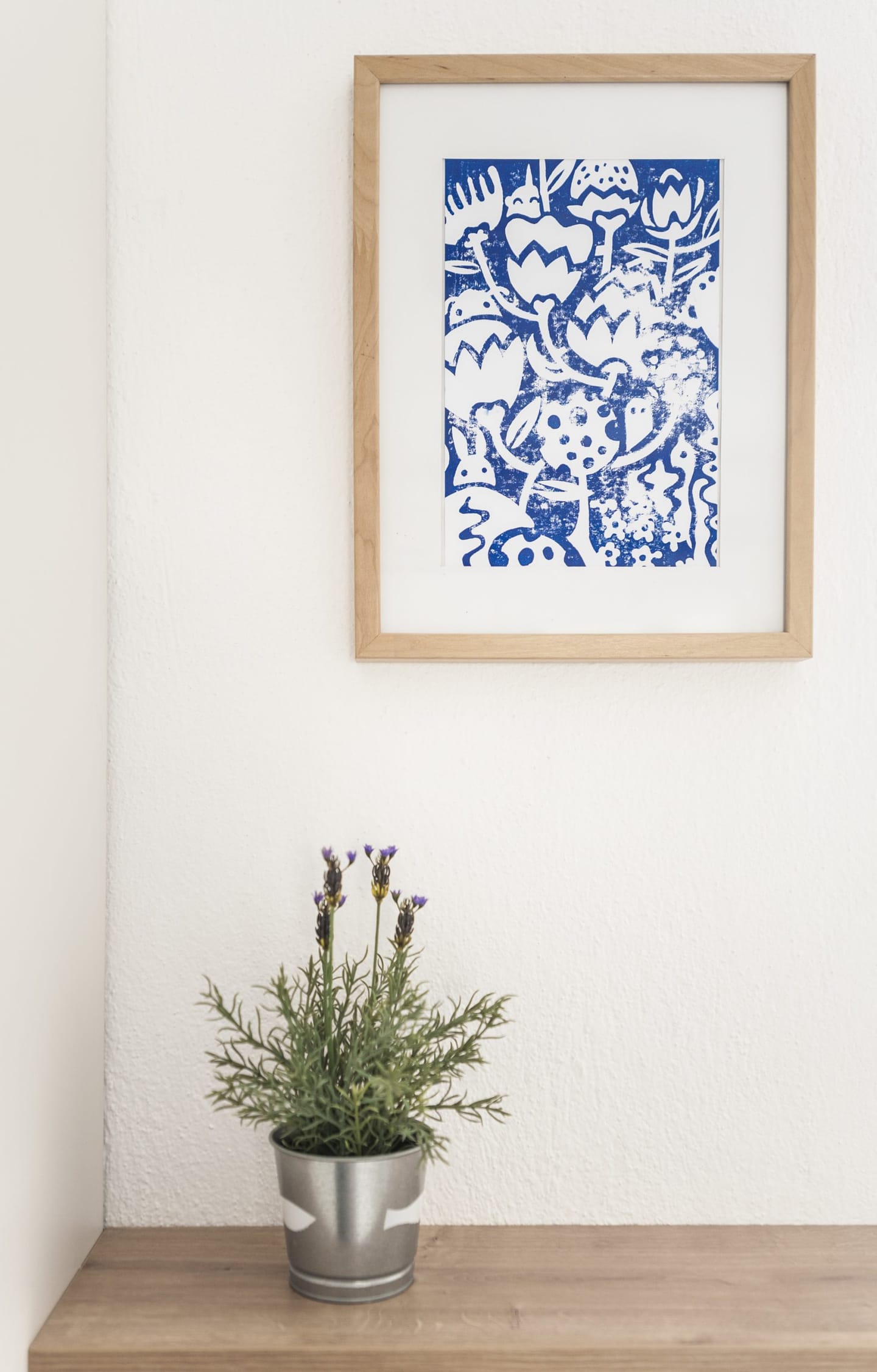 Framed blue print on a white wall