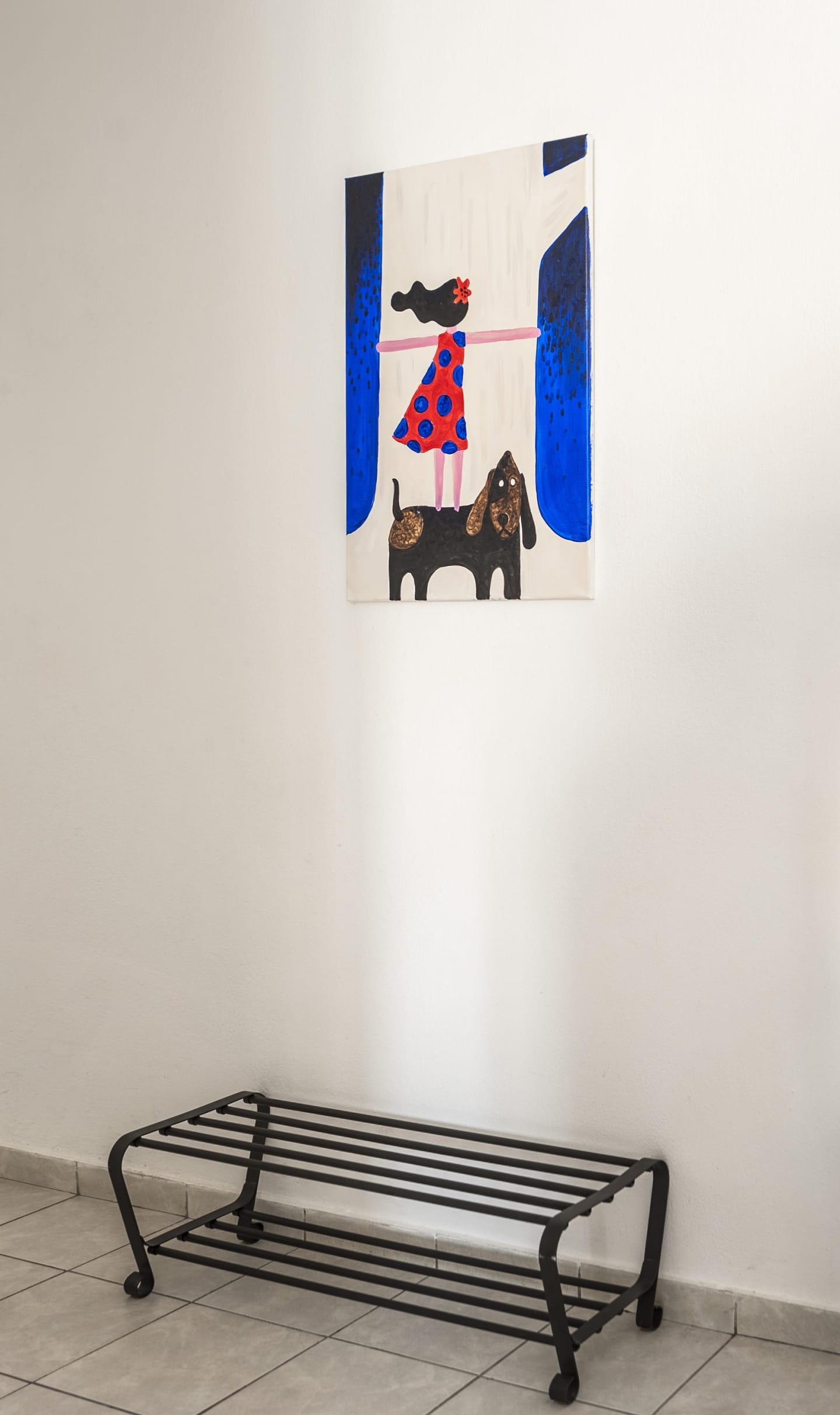 Framed drawing of a dog on a white wall